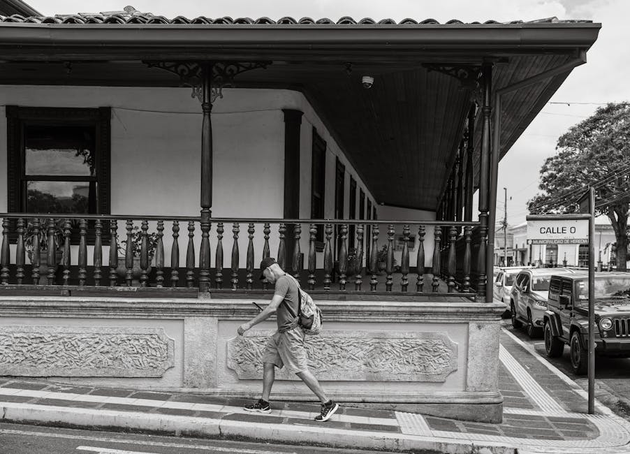 A traveler walking past historic architecture
